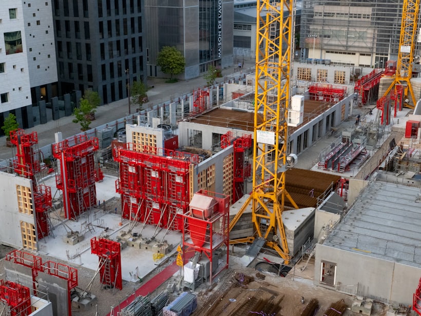 A development site with tower cranes and formwork