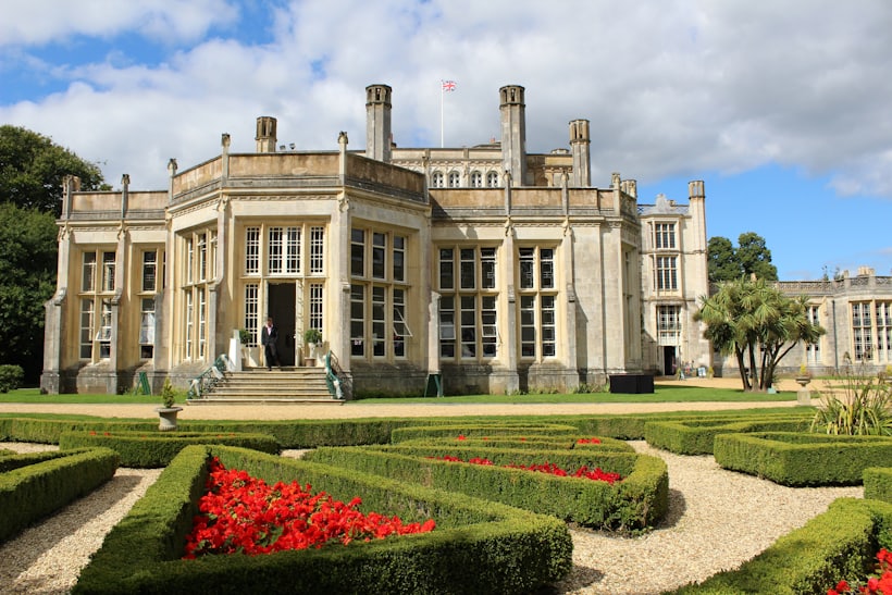 A grand stone country house with formal gardens