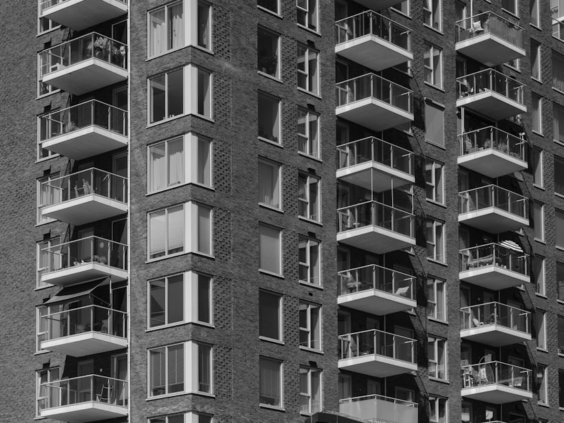 A brick apartment block with stacked balconies